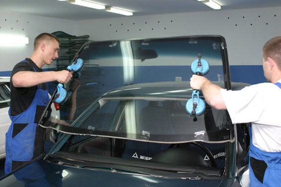 The menial of the windshield with his hands.