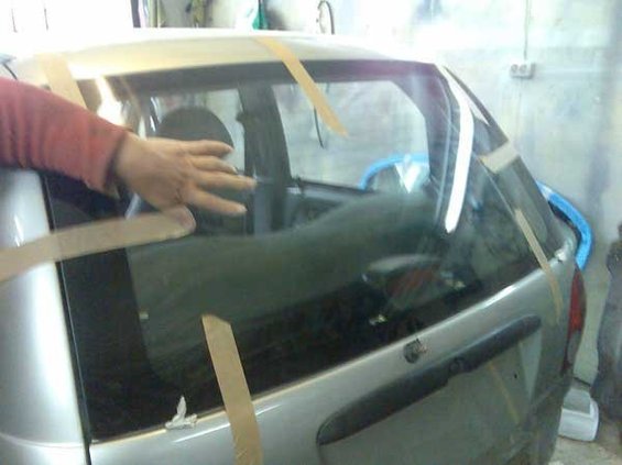 The menial of the windshield with his hands.