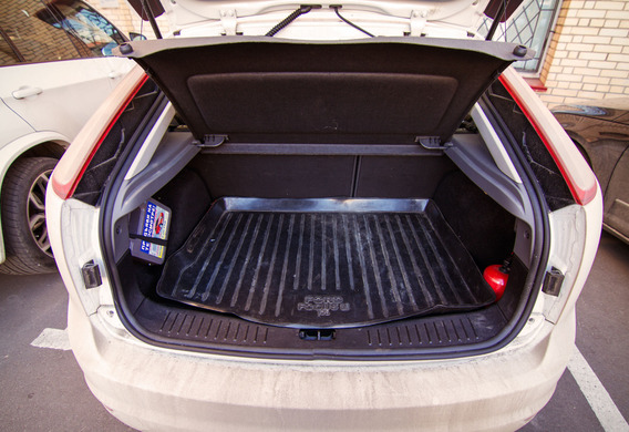 In the closed trunk, the trunk light is on the back of the Ford Focus 2